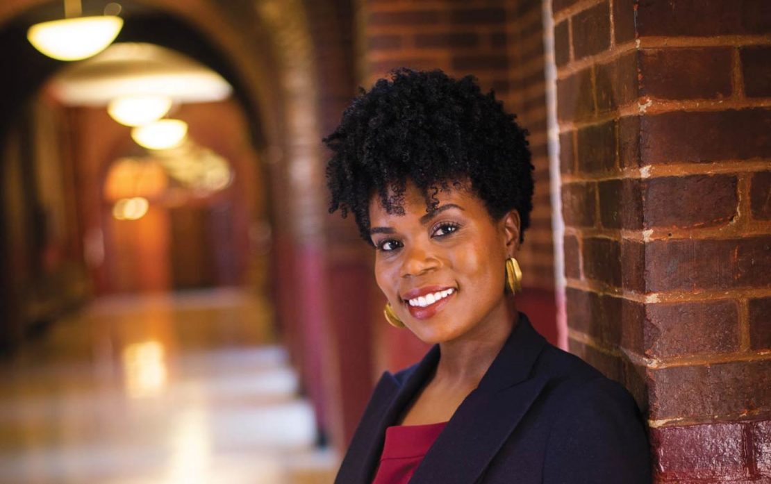 Photograph of Adanna Johnson posing in a corridor of Healy Hall at Georgetown University.